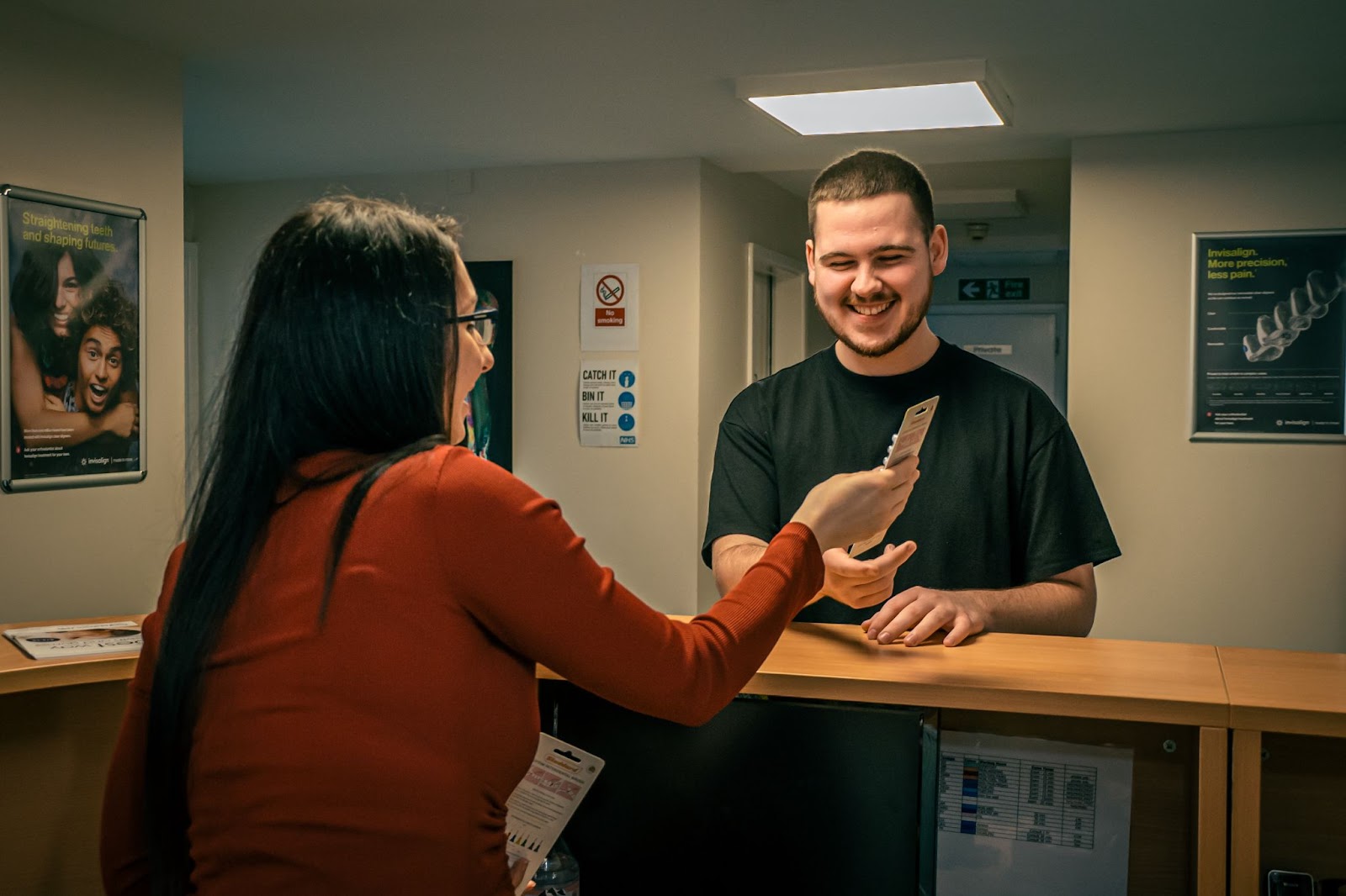 Receptionist showing plans to patient